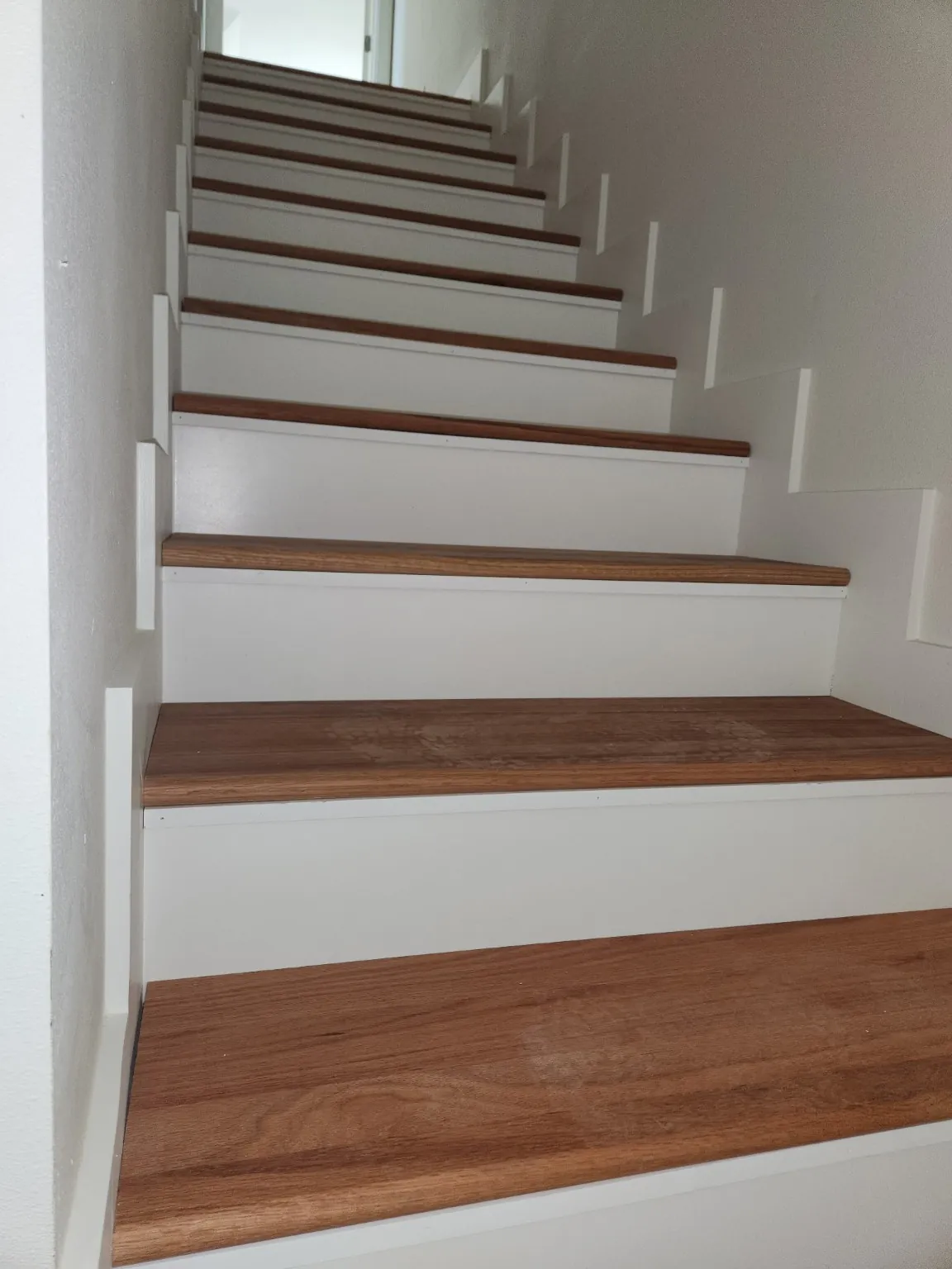 Finished wood stair treads with white risers